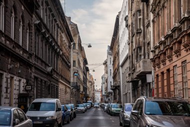 BUDAPEST, HUNGARY - 27 Şubat 2022: Budapeşte, Macaristan 'ın şehir merkezinde otomobil parkı ve konut binaları olan tipik bir caddenin panoraması.