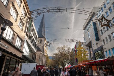 ESSEN, GERMANY - NOVEMBER 11, 2022: Panorama of Kettwiger Strasse street with a crowd of pedestrians in essen. it's the main street of the city center of Essen, with shops and markets