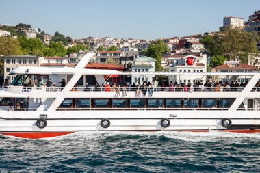 ISTANBUL, TURKEY - MAY 21, 2022: Turks standing on a ship, a ferryboat in Istanbul, a vapur, a ferry boat ship connecting Asia to Europe sides of the city