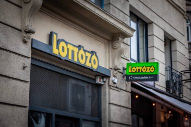 BUDAPEST HUNGARY - FEBRUARY 26, 2022: Lottozo logo on a local gambling parlor of Budapest. Also called Lottery of Hungary, it's part of the state owned Hungarian betting and gambling lottery institution