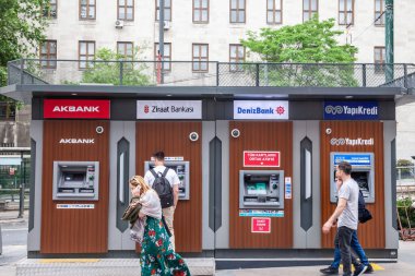 İSTANBUL, TURKEY - 20 Mayıs 2022: Seçici bulanık insanlar İstanbul 'daki ana Türk bankalarının ATM makinelerinden, Türkiye' nin ana ekonomi ve finans merkezinden para çekiyorlar