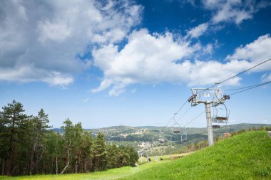 DIVCIBARE, SERBIA - JUNE 4, 2022: stopped ski lifts, not working in summer, in Divcibare ski resort, by slopes, in the middle of balkans mountain in Serbia. Divcibare is one of the main ski tourism destinations of Serbia