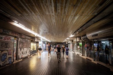 BELGRADE, SERBIA - JUNE 15, 2022: Selective blur on People in a rush walking, with a speed blur, in the underground passage of Terazije, in the city center of Belgrade