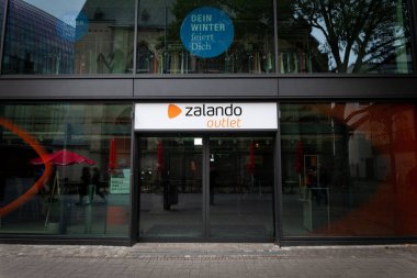 COLOGNE, GERMANY - NOVEMBER 12, 2022: Selective blur on a Zalando logo on their outlet store of Cologne. Zalando is an online german fashion retailer