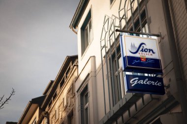 COLOGNE, GERMANY - NOVEMBER 12, 2022: Selective blur on a Sion Beer logo on a local retailer. Sion is a Kolsch beer, a traditional beer from the Cologne Region. 