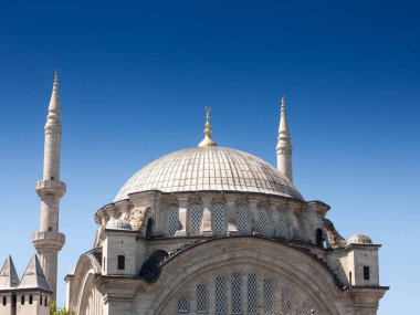 Main building of of an ottoman mosque during sunny afternoon; with its dome and minarets in the Fatih district in istanbul, Turkey., on a sunny afternoon.