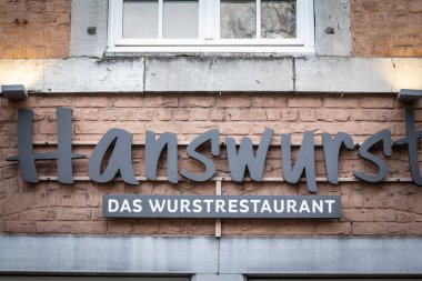 Hanswurst Aachen Logosu, sosis üzerine uzmanlaşmış bir restoran, tipik bir Alman sosisi, Alman mutfağının sembolü..