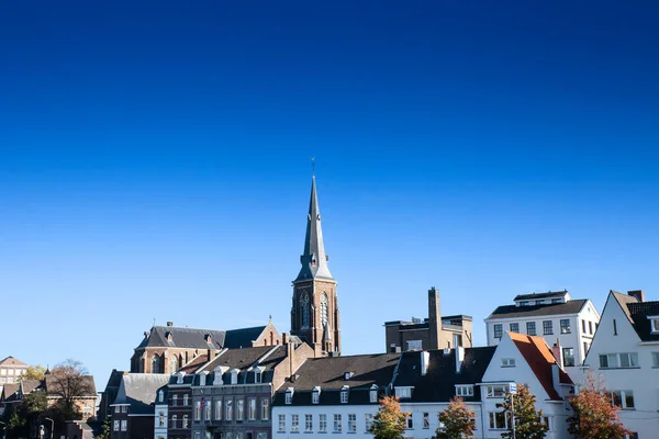 stock image Panorama of the Maastricht Waterfront on the Meuse Maas river with a focus on the Sint Martniuskerk, a catholic church, and the ridder brewery in maastricht, Netherlands.