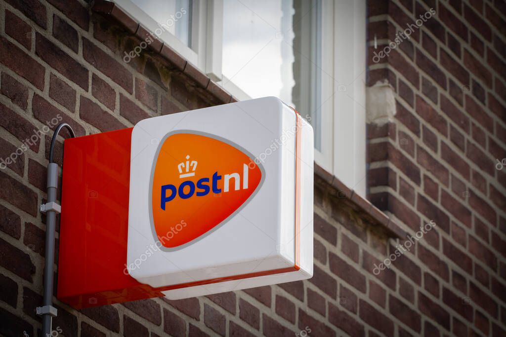VAALS, NETHERLANDS - NOVEMBER 8, 2022: PostNL logo on their office in Vaals. PostNL, or Post NL is a dutch mail parcel and shipping delivery company.