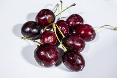 Stüdyo çekiminde, kırmızı kirazların üzerindeki seçici bulanıklık. Prunus cerasus olarak da bilinen kiraz, ekşi kiraz olarak da bilinen bir meyvedir..