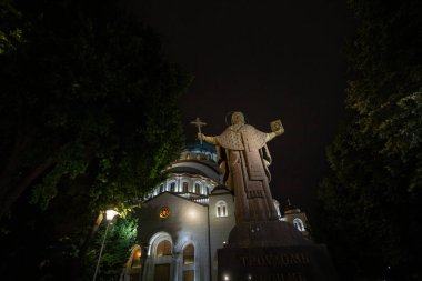 BELGRAD, SERBIA - 14 Haziran 2018: Aziz Sava Katedral Tapınağı 'nda (Hram Svetog Save) gece önünde Aziz Sava anıtı bulunan seçici bulanıklık. Bu ortodoks kilisesi Belgrad 'ın bir anıtı.