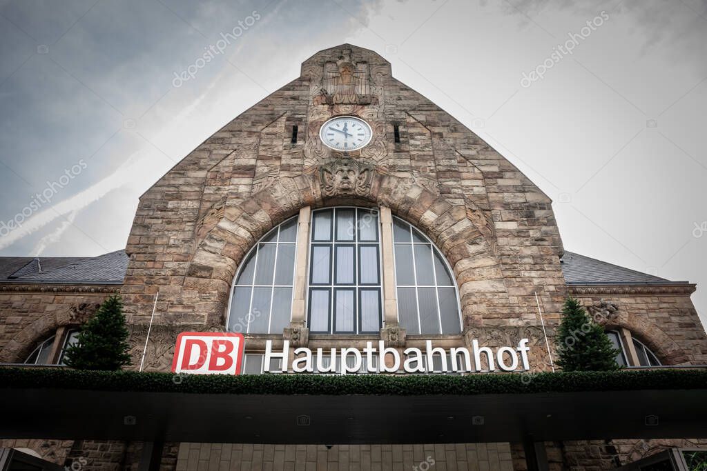 AACHEN, GERMANY - NOVEMBER 8, 2022: Main facade of Aachen Hbf , meaning Aachen Hauptbahnhof, in german the main train station of the city of Aachen, at dusk. It's a major Deutsche Bahn hub.