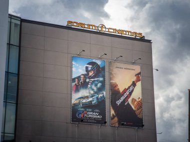 RIGA, LATVIA - AUGUST 21, 2023: Riga cinema displaying the current box office: two american movies: Gran Turismo and The Equalizer 3 with denze washington, translated in latvian Stabilizators 3. clipart