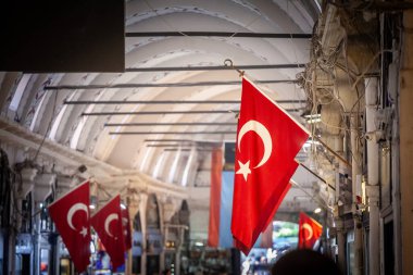 Selective blur on Turkish flags hung in the grand bazaar. Also known as kapalicarsi, it is one of the main landmarks and touristic attractions of the city. clipart
