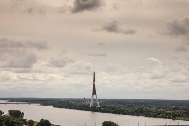Panorama of the Daugava river seen from above with the riga radio and tv tower in Riga, latvia. Also called rigas radio un televizijas tornis, it's a broadcasting antenna and a landmark. clipart