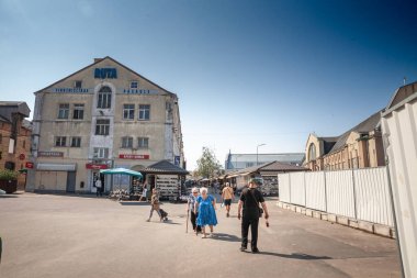 RIGA, LATVIA - AUGUST 23, 2023: Panorama of decaying buildings of Centraltirgus, Riga Central market, a landmark and a symbol of latvian economy, during a sunny afternoon. clipart