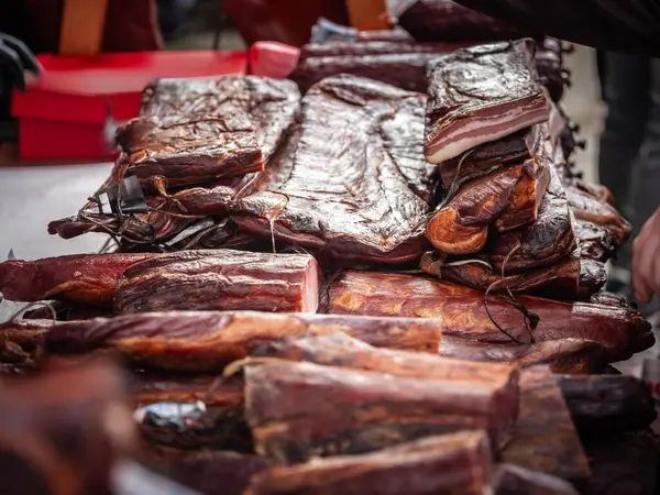 stock image Selective blur on blocks of slanina, a serbian bacon, made of dried cured pork, smoked, on the stand of a countryside market of Serbia. It's a traditional meat product from Balkans.