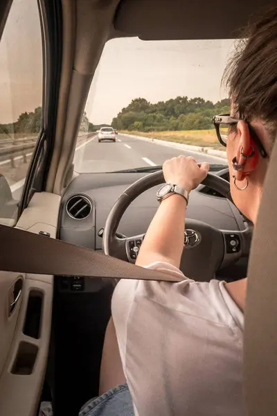 Stock image BELGRADE, SERBIA - JULY 31, 2021: Woman driving a car, a toyota, with her seatbelt fastened on a road in rural serbia, in the balkans.