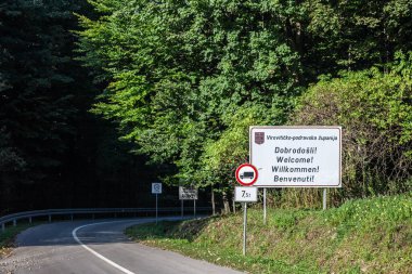 PAPUK, CROATIA - SEPTEMBER 19, 2023: Viroviticko podravska zupanija girişini gösteren yol işareti papuk doğa parkında Hırvat kırsal kesiminde bir kölelik yolunda.