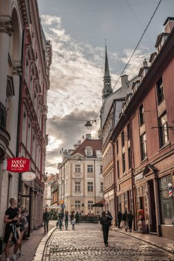 RIGA, LATVIA - AUGUST 21, 2023: Panorama audelu iela, a narrow street in Riga, a pedestrian cobblestone street of Vecriga Vecpilseta, the historical center old town of Latvian capital city. clipart