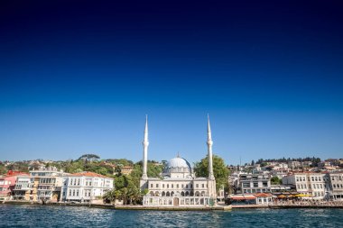 Panorama of beylerbeyi mosque, also called hamid i evvel camii, in front of the sea Bosphorus strait in uskudar district on a sunny afternoon in Istanbul, Turkey. it's an ottoman muslim mosque. clipart