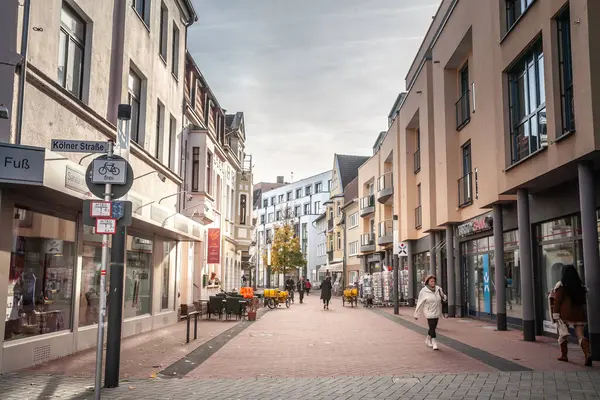 Stock image TROISDORF, GERMANY - NOVEMBER 12, 2022: Panorama of Hippolytusstrasse of Troisdorf, typical german high street in suburban environment with people walking passing by shops & stores, in Cologne suburbs.