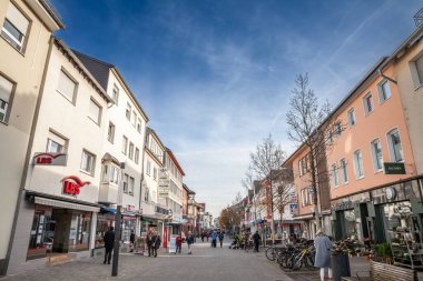 TROISDORF, GERMANY - NOVEMBER 12, 2022: Panorama of Kolner strasse of Troisdorf, a typical german main street in suburban environment with people walking passing by shops and stores, in the suburbs of Cologne. clipart