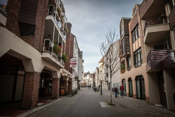 stock image TROISDORF, GERMANY - NOVEMBER 12, 2022: Panorama of the city center of Troisdorf, a typical german main street in suburban environment with people walking passing by shops and stores, in the suburbs of Cologne.