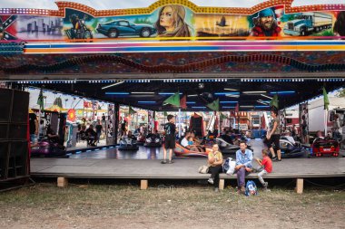 SABAC, SERBIA - SEPTEMBER 21, 2023: Serbian Family Enjoying Bumper Cars at Carnival and amusement park of sabacki vasar. clipart