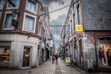 LIEGE, BELGIQUE - 9 Kasım 2022: Liege şehir merkezinin yaya sokağı Rue du Pont d 'or' daki seçici bulanıklık, eski binalar, dükkanlar ve butikler ön cephelerinde simgesel işaretler olan.