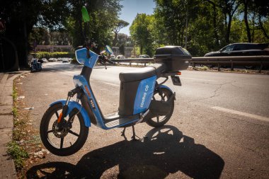 ROME, ITALY - JUNE 15, 2024: A Cooltra electric scooter parked on a street in Rome. Cooltra is a spanish mobility company specialized in electric scooter rentals. clipart