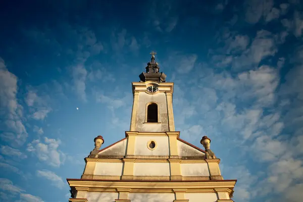 stock image A striking image of an old orthodox church in Banat, Serbia. The church's architectural details stand out against a clear blue sky, emphasizing its historical and cultural significance in the region.