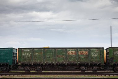 JELGAVA, LATVIA - AUGUST 20, 2023: Open Wagons, also called Gondola wagons on a yard of latvian railways in jelgava, belonging to RZHD Russian railways using them for exports despite sanctions. clipart