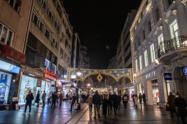 Belgrade, Serbia - December 9, 2023: Selective blur on a Crowd walking at night on Kneza Mihailova street with shops in old town decoration and illuminated for New Year and Christmas. clipart