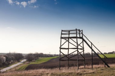 A bird watchtower stands amidst the natural landscape of Deliblatska Peara in Banat, Vojvodina, Serbia, offering panoramic views for observing wildlife in this protected area known for its unique sand dunes and biodiversity clipart