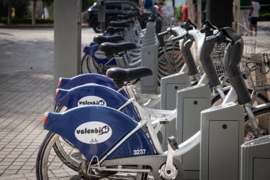 VALENCIA, İspanya - 13 Ekim 2024 Valenbisi bisikletleri bir sıra halinde Valencia 'daki bir kenetlenme noktasına yerleştirildi. Valenbisi, JCdecaux tarafından işletilen Valencia 'nın bisiklet paylaşım sistemi..