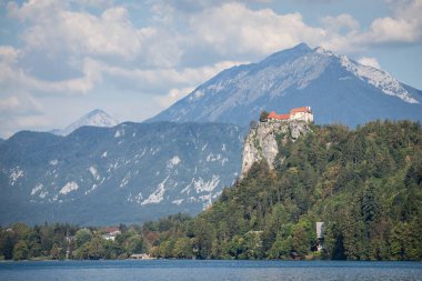 Panorama of the Bled lake, Blejsko Jezero, with its castle, Blejski Hrad, during a sunny summer with the mountains of Julian alps. Bled Castle is a major monument of Slovenia. clipart