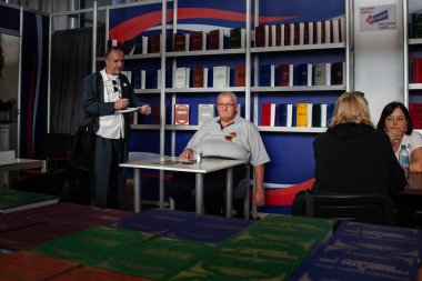 BELGRADE, SERBIA - OCTOBER 12, 2024: Vojislav Seselj stands before a collection of his books in Belgrade, Serbia. Vojislav Seselj is a nationalist serbian politician. clipart