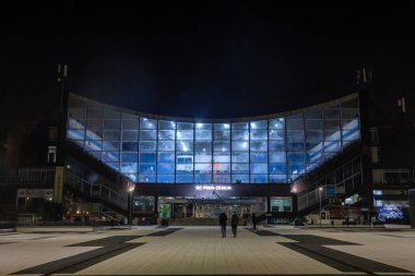 BELGRADE, SERBIA - OCTOBER 12, 2024: Pinki Hall, or Hala Pinki, in Zemun, Serbia, is illuminated at night. KSC Pinki is a sports hall and cultural venue in Zemun. clipart