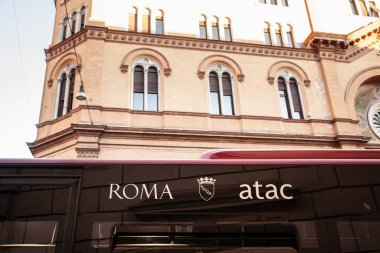 ROME, ITALY - JUNE 15, 2024: The Atac logo displayed on a city bus signals Romes municipal transport system; azienda tranvie e autobus del comune di roma or atac is the transportation operator clipart