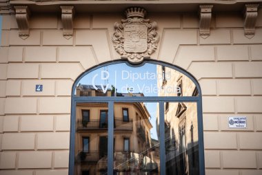 VALENCIA, SPAIN - OCTOBER 12, 2024: The main entrance to Diputacio de Valencia, the local government body of comunidad valenciana, the regional valencian community in the Palacio de la Baylia. clipart