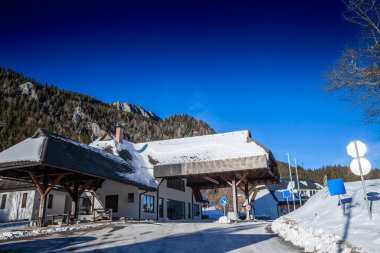 Abandoned Jezerski vrh border crossing on Seeberg Saddle, with snow-covered alpine surroundings and open borders between Slovenia and Austria since Slovenia is part of Schengen & European Union. clipart