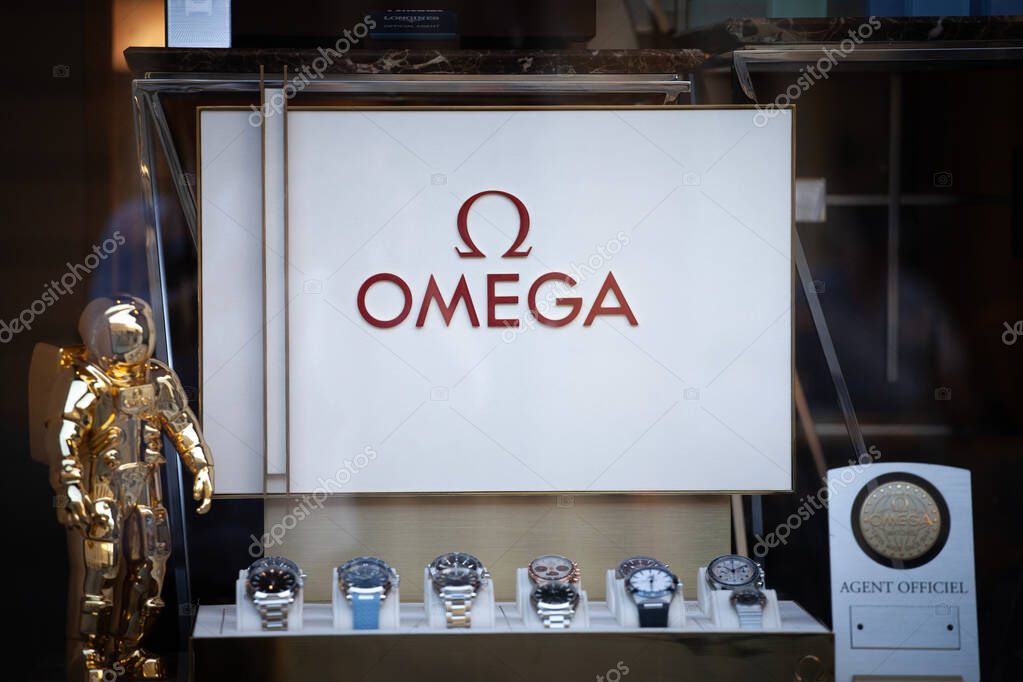 BELGRADE, SERBIA - OCTOBER 12, 2024: Omega logo in front of watches in a retailer boutique in Belgrade. Omega is a Swiss luxury swiss watchmaker.
