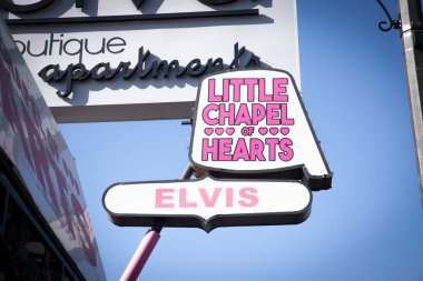 LAS VEGAS, AUGUST 21, 2024: A pink sign for the Little Chapel of Hearts stands along Las Vegas Boulevard, advertising quick, themed weddings and vow renewals in a city famous for its marriage industry. clipart