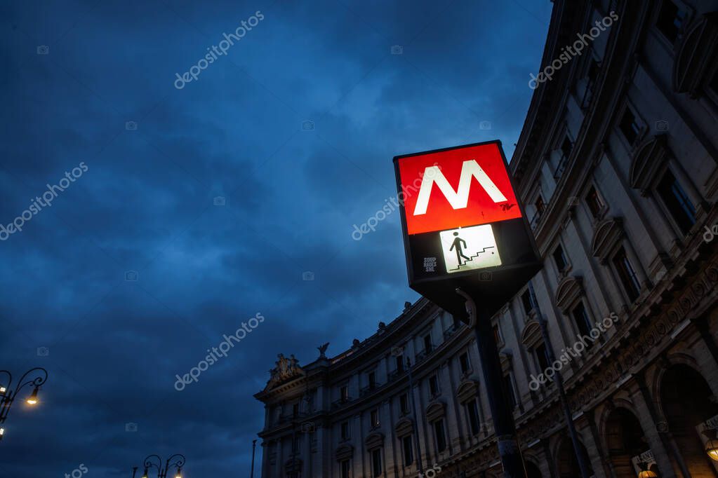 ROME, ITALY - JANUARY 15, 2025: Rome Metro station sign at night, marking the subway entrance. The Rome subway, operated by Atac, is one of the transit system of the italian capital city.