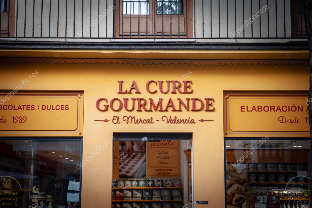 VALENCIA, SPAIN - OCTOBER 13, 2024: Front of La Cure Gourmande sweet shop in Valencias El Mercat quarter. la Cure Gourmande is a french confectionery and candy shop chain and manufacturer