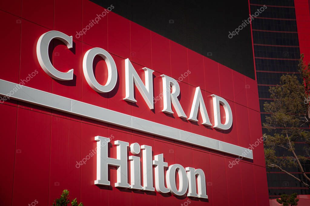 LAS VEGAS, AUGUST 21, 2024: Logos of Conrad Hotels and Hilton hotels and resorts on their tower in Las Vegas, Resorts World Las vegas.