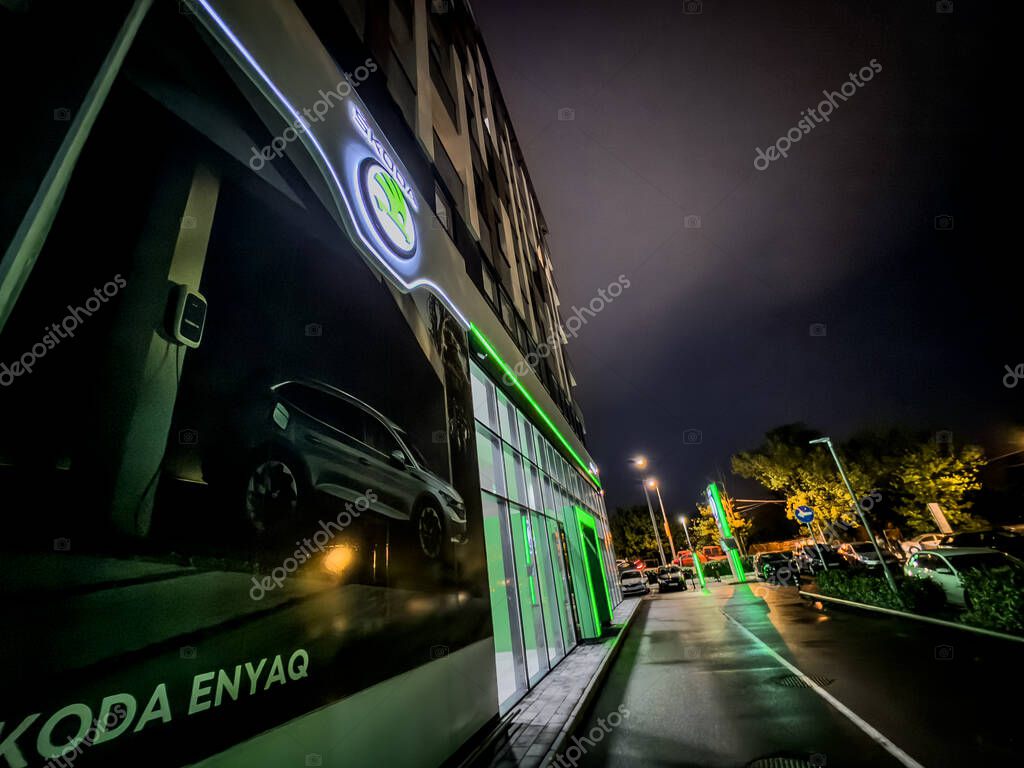 BELGRADE, SERBIA - APRIL 22, 2025: Night street view of a Belgrade Skoda dealership where a luminous skoda logo; Skoda is a czech automaker, part of Volkswagen group.