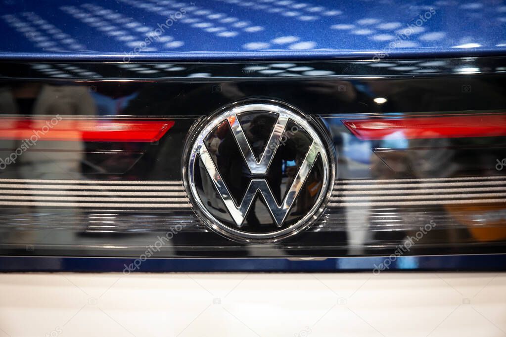BELGRADE, SERBIA - MARCH 15, 2025: Close-up of a Volkswagen emblem on a blue car's front grille in a dealership. Volkswagen is a German car and automotive manufacturer.