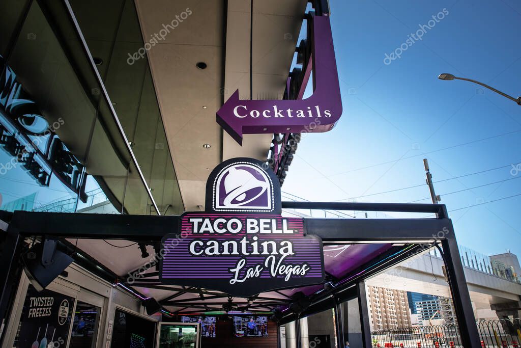 LAS VEGAS, AUGUST 21, 2024: The Taco Bell Cantina on the Las Vegas Strip is captured from street level, showing the purple arrow 'Cocktails' sign and the franchise's bell logo over the open air entrance.